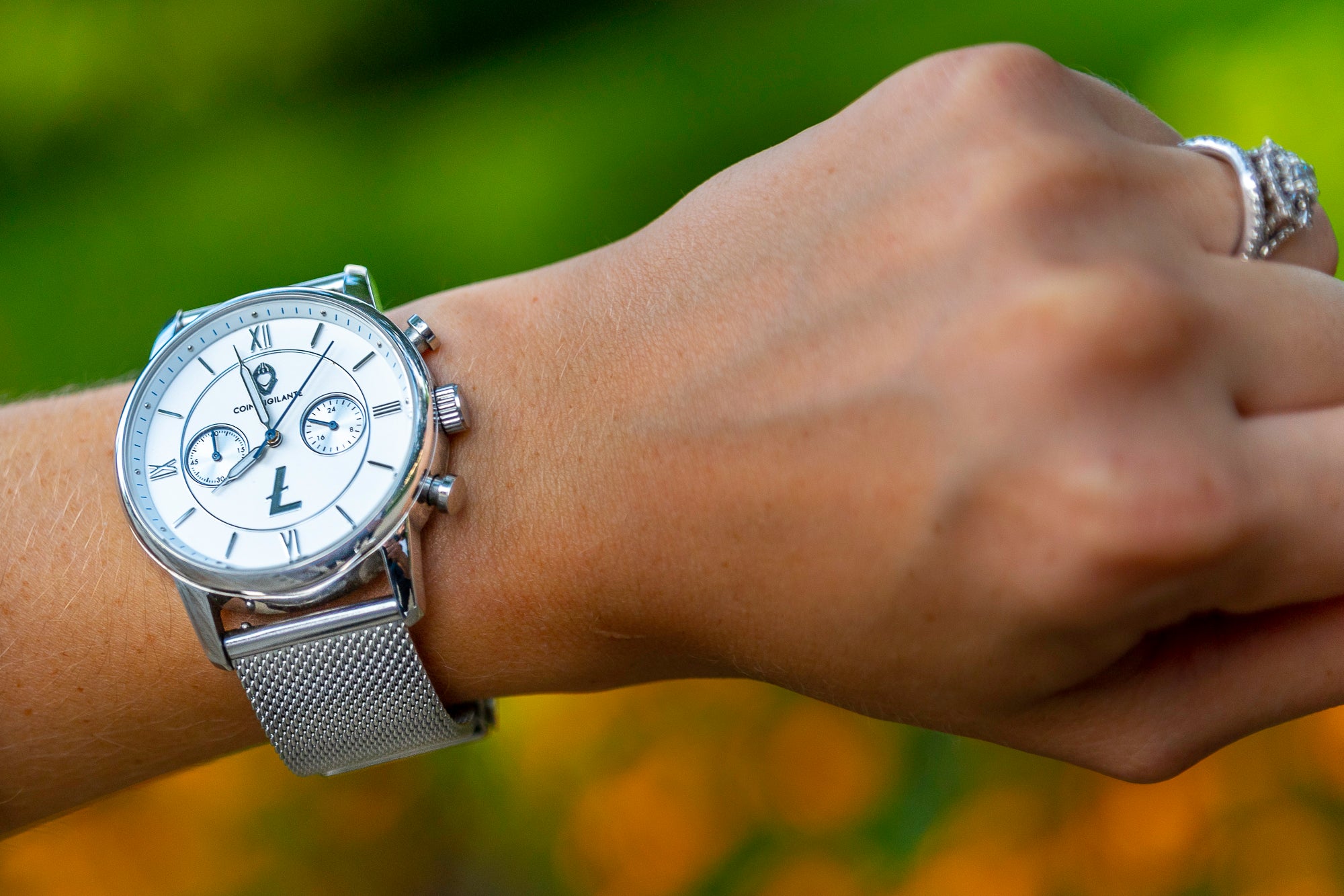 Coin Vigilante Silver Stainless Steel Mesh Band displayed on lady's wrist